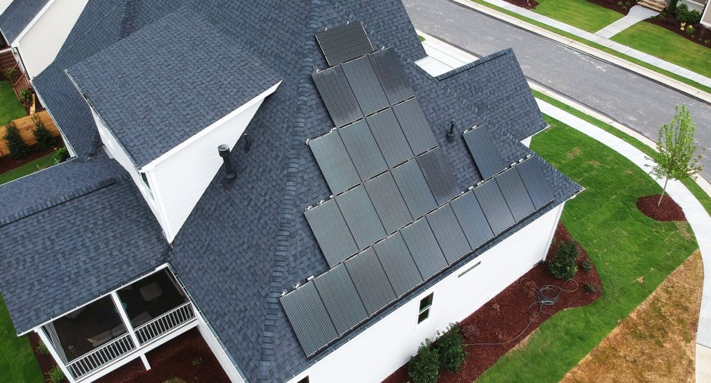 white house with black solar panels